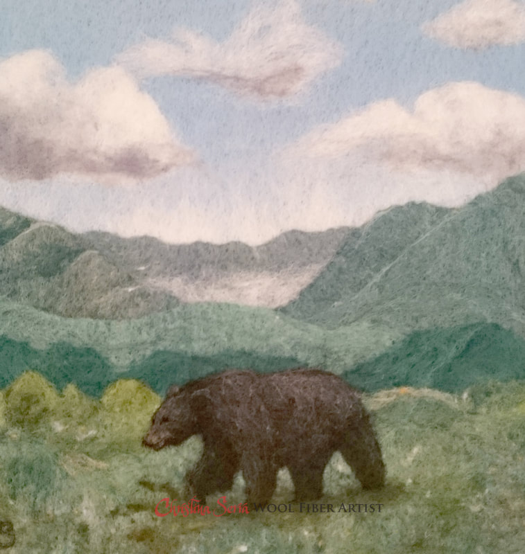 artwork wool painting of a black bear walking on a hillside in the appalachian mountains with a background of mountains and blue sky with puffy clouds.